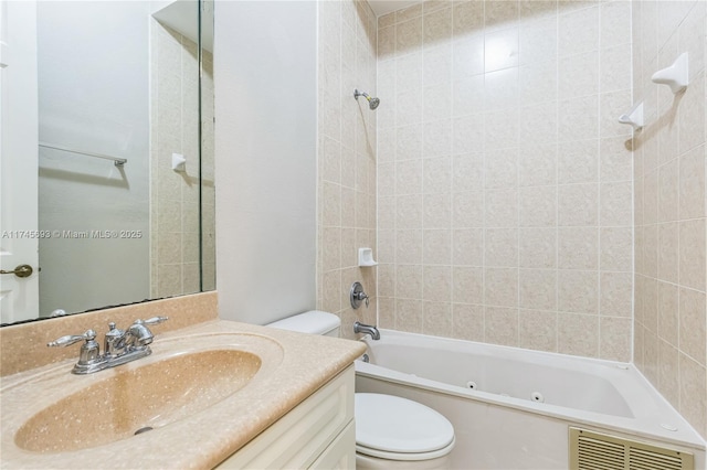 bathroom featuring a combined bath / shower with jetted tub, visible vents, vanity, and toilet