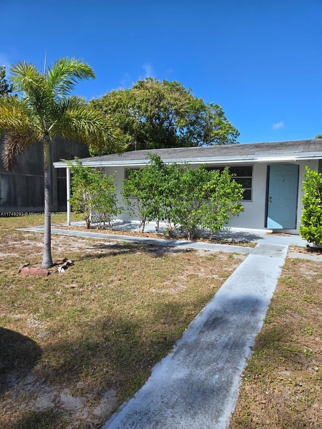 exterior space with fence and a lawn