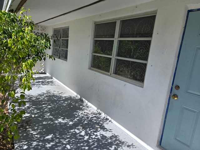 doorway to property with stucco siding