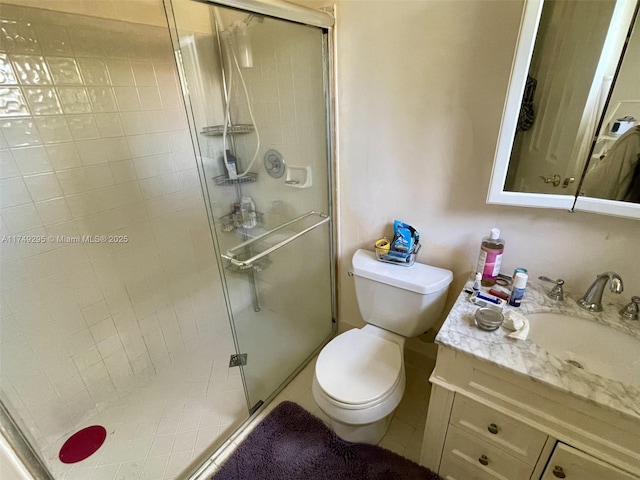 full bath featuring toilet, a stall shower, and vanity