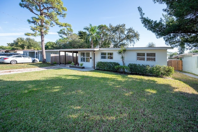 single story home featuring a front lawn, fence, and stucco siding