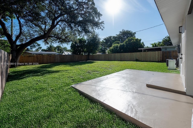 view of yard featuring a patio and a fenced backyard