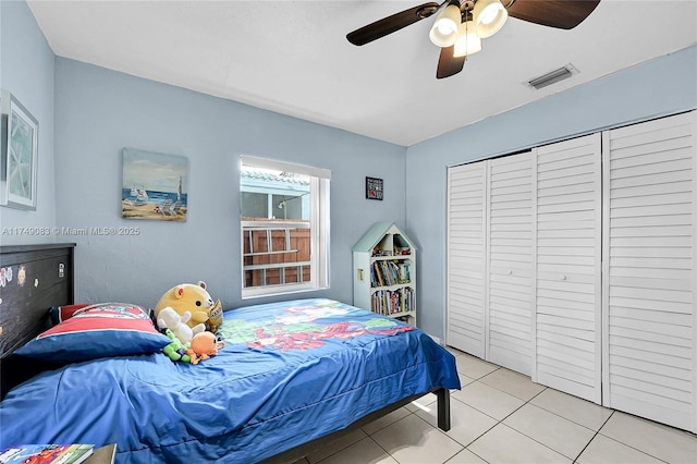 bedroom featuring a ceiling fan, visible vents, and light tile patterned flooring