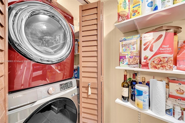 laundry area featuring stacked washer and dryer, tile patterned flooring, and laundry area