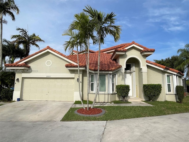 mediterranean / spanish-style home with stucco siding, a tiled roof, concrete driveway, and a garage