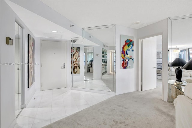 corridor with light carpet, light tile patterned floors, and recessed lighting