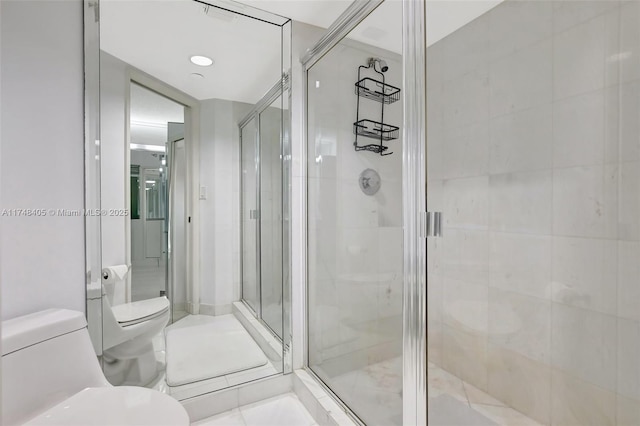 full bathroom with tile patterned flooring, a shower stall, and toilet