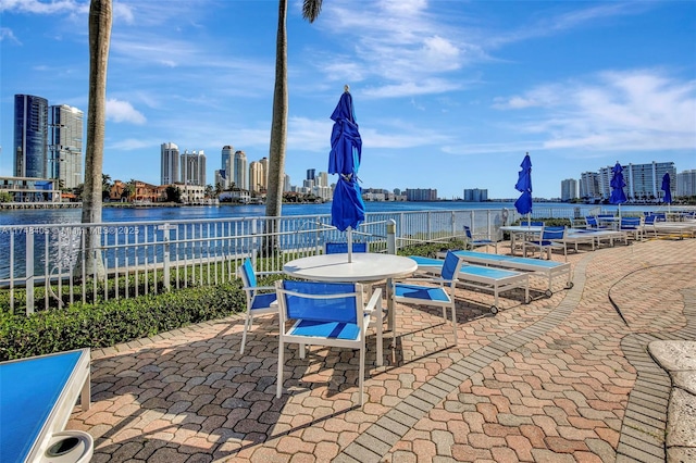 view of patio / terrace featuring a city view and a water view