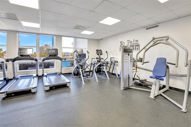 gym featuring a drop ceiling, visible vents, and baseboards