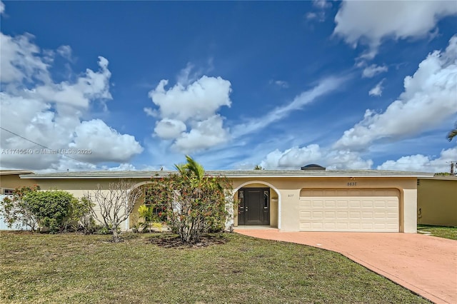 ranch-style home with a front yard, decorative driveway, an attached garage, and stucco siding