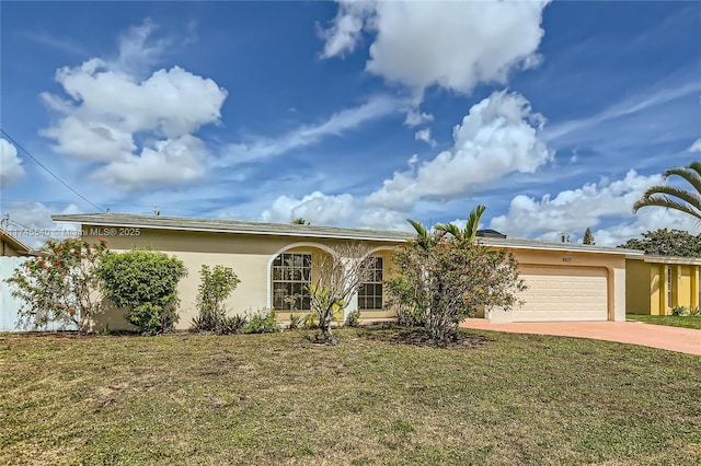 single story home featuring a front yard, driveway, and stucco siding