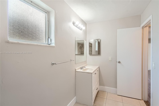 bathroom featuring baseboards, vanity, and tile patterned floors