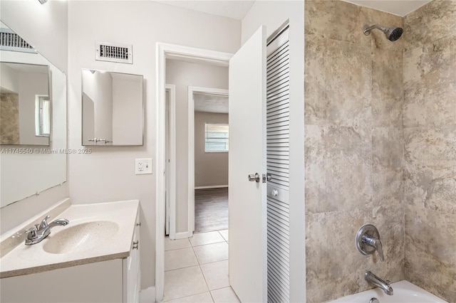 full bathroom with vanity, visible vents, a closet, tub / shower combination, and tile patterned floors