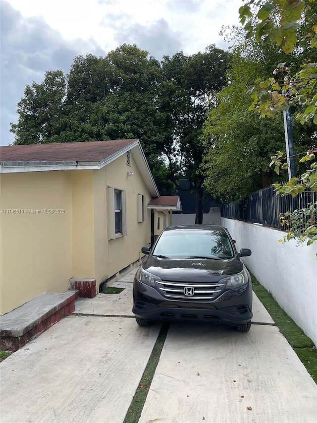 120 NE 75th St, Miami, FL 33138 - view of side of home with fence and stucco siding