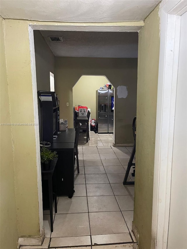 120 NE 75th St, Miami, FL 33138 - hall featuring arched walkways, visible vents, and light tile patterned floors