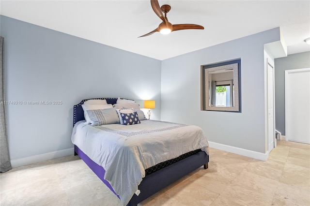 bedroom with ceiling fan and baseboards