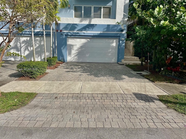 garage featuring decorative driveway