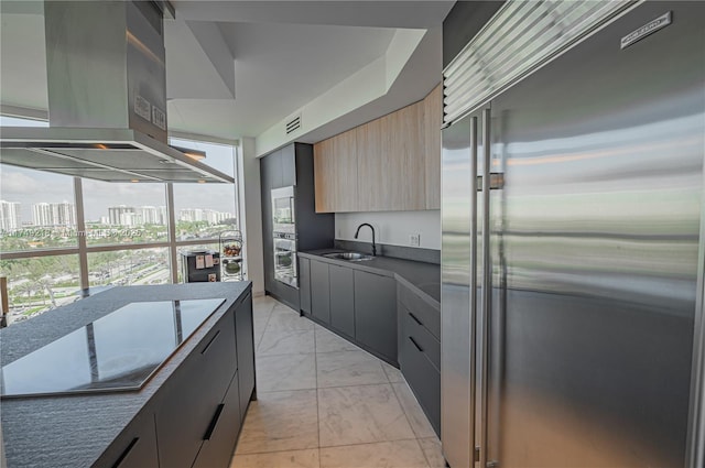 18201 Collins Ave Unit 1201, Sunny Isles Beach, FL 33160 - kitchen with appliances with stainless steel finishes, island exhaust hood, light marble finish floors, modern cabinets, and a city view