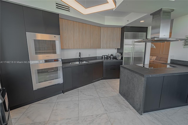 18201 Collins Ave Unit 1201, Sunny Isles Beach, FL 33160 - kitchen with island exhaust hood, appliances with stainless steel finishes, dark countertops, modern cabinets, and a sink
