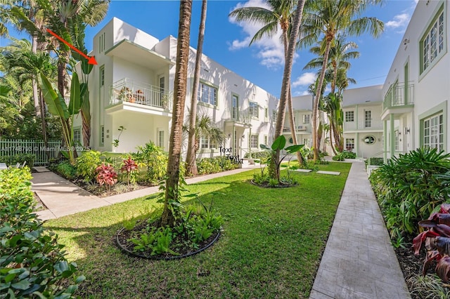 surrounding community with a residential view, a yard, and fence