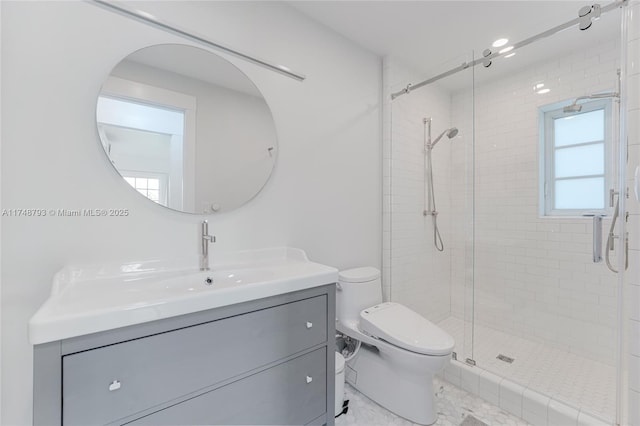 full bath with a stall shower, vanity, and toilet