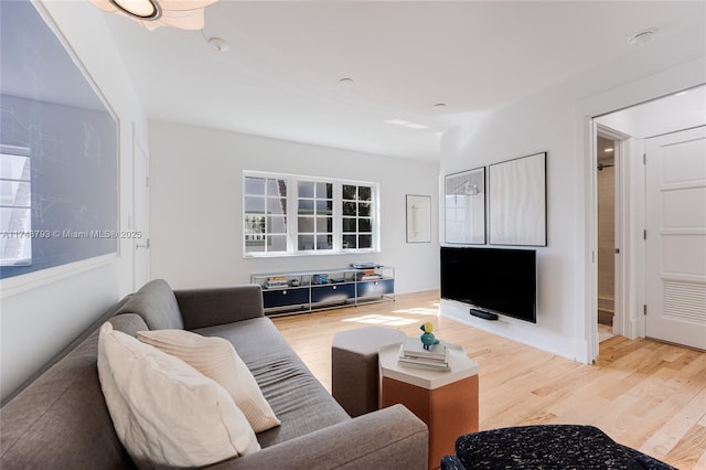 living room with baseboards and wood finished floors