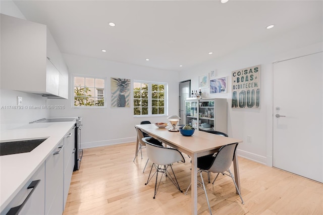 kitchen featuring light countertops, light wood-style floors, recessed lighting, and white cabinets