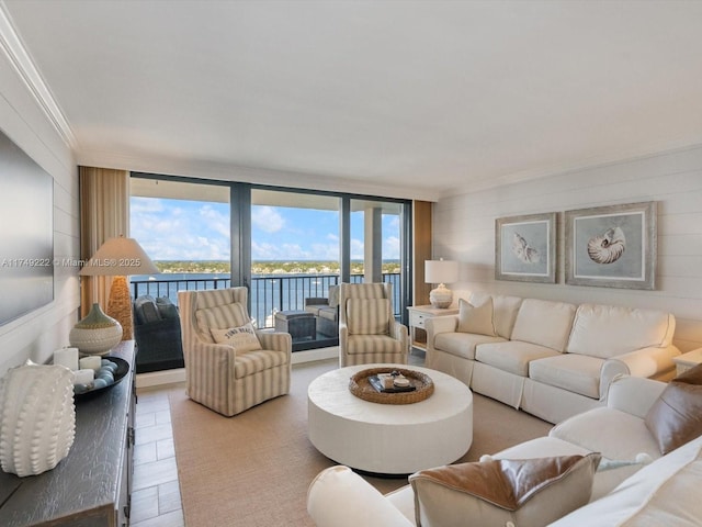 living area featuring expansive windows, ornamental molding, and light wood finished floors