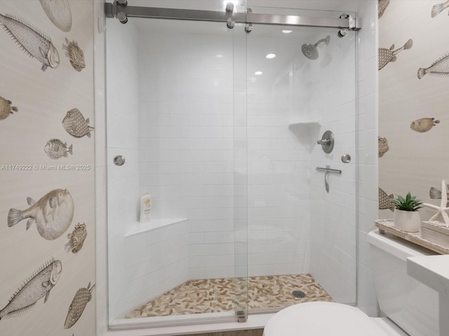 full bath featuring a stall shower and toilet