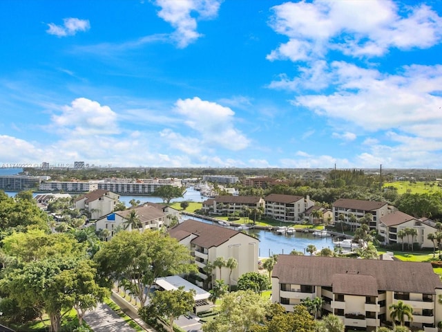 drone / aerial view featuring a water view and a residential view