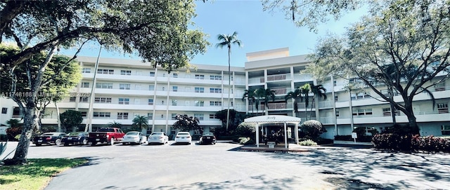 3800 Oaks Clubhouse Dr Unit 112, Pompano Beach, FL 33069 - view of apartment building / complex featuring uncovered parking