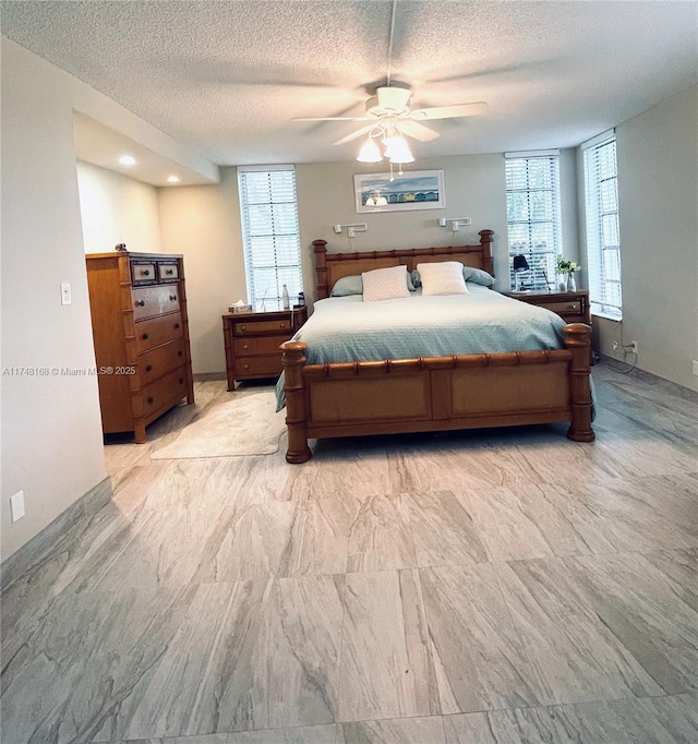 bedroom featuring ceiling fan and a textured ceiling