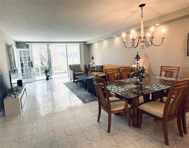3800 Oaks Clubhouse Dr Unit 112, Pompano Beach, FL 33069 - dining space with a chandelier, a textured ceiling, and light tile patterned floors