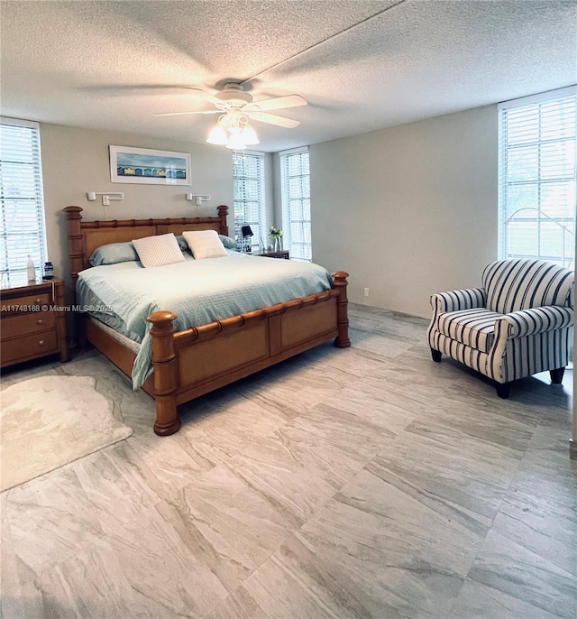 3800 Oaks Clubhouse Dr Unit 112, Pompano Beach, FL 33069 - bedroom with multiple windows, a textured ceiling, and ceiling fan