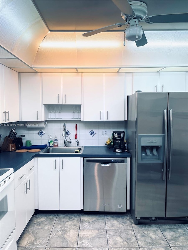 3800 Oaks Clubhouse Dr Unit 112, Pompano Beach, FL 33069 - kitchen featuring appliances with stainless steel finishes, a sink, white cabinetry, ceiling fan, and dark countertops