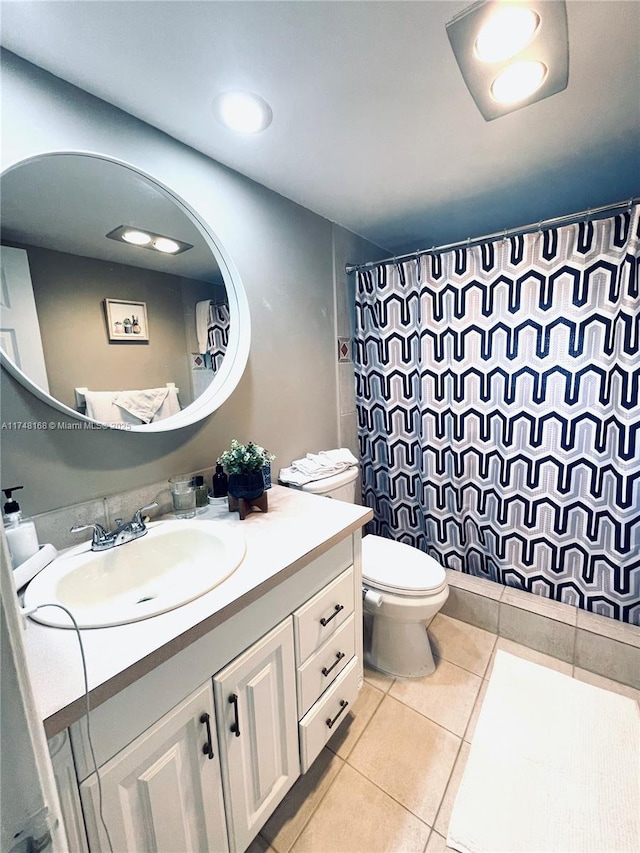 3800 Oaks Clubhouse Dr Unit 112, Pompano Beach, FL 33069 - bathroom featuring tile patterned flooring, vanity, toilet, and a shower with shower curtain