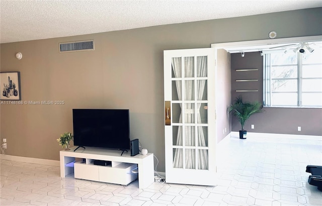 3800 Oaks Clubhouse Dr Unit 112, Pompano Beach, FL 33069 - unfurnished living room with a textured ceiling, tile patterned floors, and baseboards