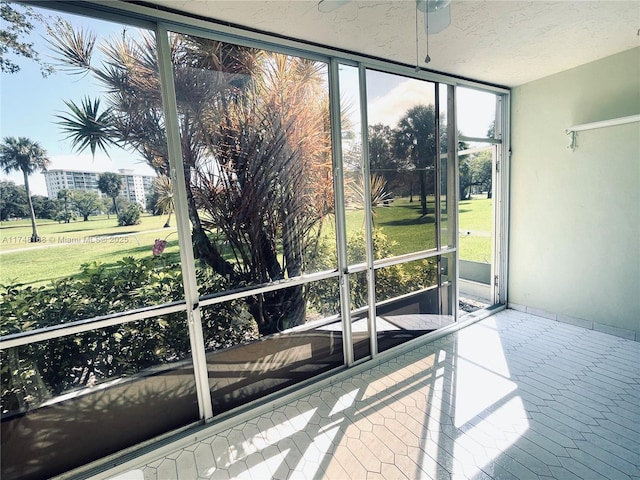 3800 Oaks Clubhouse Dr Unit 112, Pompano Beach, FL 33069 - unfurnished sunroom featuring a ceiling fan