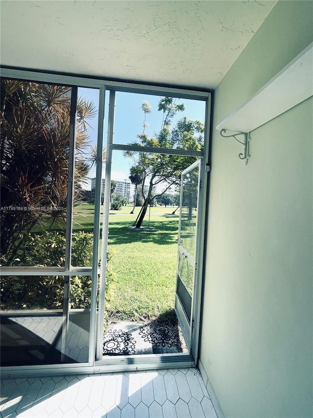 3800 Oaks Clubhouse Dr Unit 112, Pompano Beach, FL 33069 - entryway featuring expansive windows and tile patterned floors