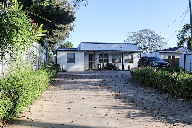 bungalow featuring fence and stucco siding