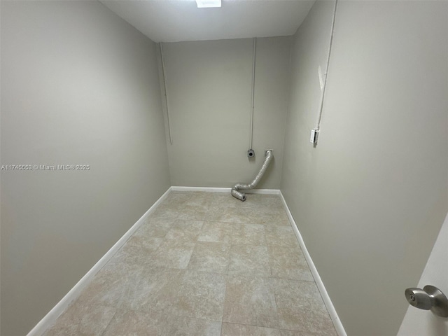 laundry area featuring baseboards