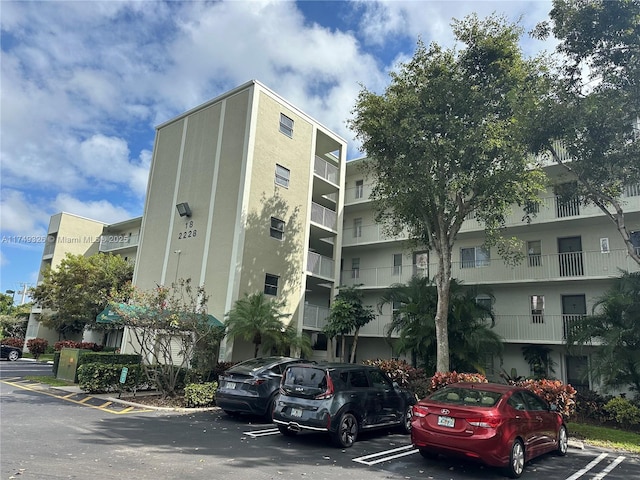 view of building exterior with uncovered parking