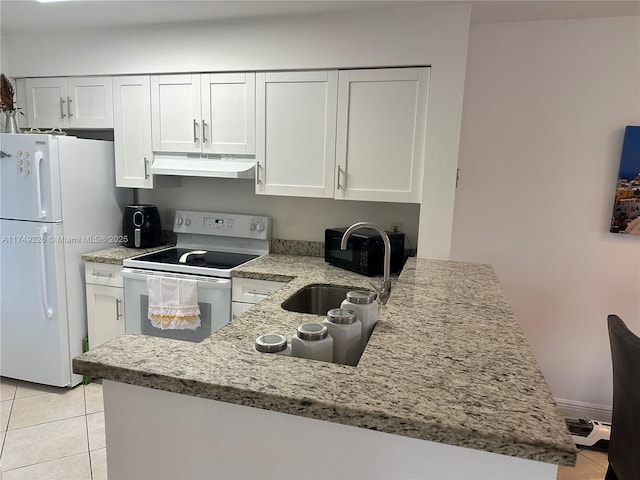 kitchen featuring a peninsula, white appliances, and white cabinets