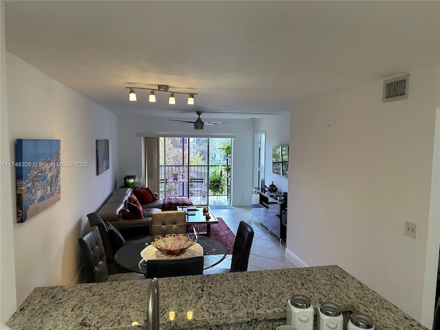 living room with visible vents, ceiling fan, and light tile patterned floors