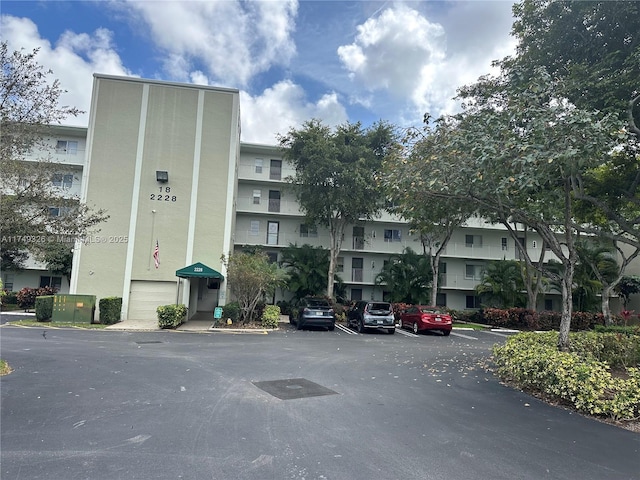 view of building exterior featuring uncovered parking