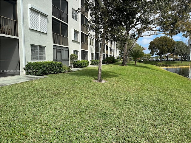 surrounding community featuring a water view and a yard