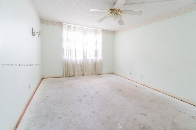 empty room with ceiling fan, baseboards, and a textured ceiling