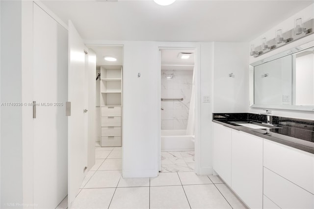 bathroom featuring a walk in closet, vanity, and shower / bathtub combination with curtain