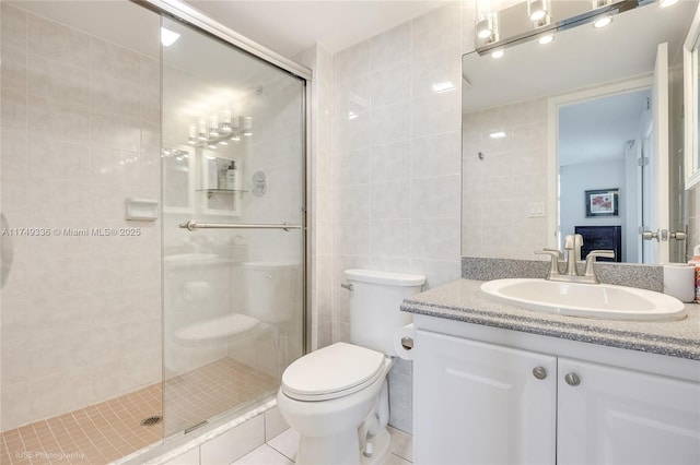 full bathroom with a stall shower, tile walls, toilet, and tile patterned floors