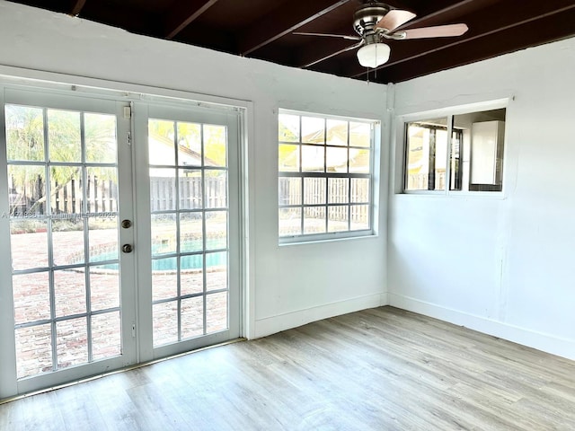 entryway featuring french doors, light wood-type flooring, a ceiling fan, and baseboards